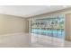Bright living room with tile floors showcasing large sliding doors with a view of the screened-in pool at 3572 Ferndell, Sarasota, FL 34235