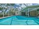 An inviting screened-in pool area with clear blue water and ample space for relaxation at 3572 Ferndell, Sarasota, FL 34235