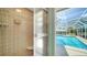 Modern shower with tiled walls and glass door, attached to screened in pool at 3572 Ferndell, Sarasota, FL 34235