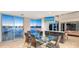 Dining area featuring a glass table, water views, and access to the outdoors at 360 N Washington Dr, Sarasota, FL 34236