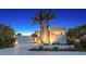 Stunning modern home featuring palm trees and a well-manicured front yard under a beautiful twilight sky at 360 N Washington Dr, Sarasota, FL 34236