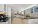 Modern kitchen featuring stainless steel appliances, granite countertops, and white cabinets at 360 N Washington Dr, Sarasota, FL 34236