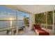 Relaxing patio with waterfront views, comfortable seating, and tropical landscaping at 360 N Washington Dr, Sarasota, FL 34236