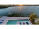 Beautiful sunset view of the pool and deck area overlooking the bay at 360 N Washington Dr, Sarasota, FL 34236