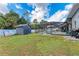 Grassy backyard with a shed and screened pool, perfect for outdoor activities and relaxation at 4415 Sylvania Ave, North Port, FL 34286