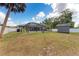 Landscaped backyard featuring a screened pool, shed, and ample green space at 4415 Sylvania Ave, North Port, FL 34286