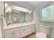 Bathroom has a vanity with a single sink, large mirror, tiled floor and a toilet at 4415 Sylvania Ave, North Port, FL 34286