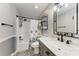 Charming bathroom with modern vanity, decorative floor tiles, and shower with patterned curtain at 4415 Sylvania Ave, North Port, FL 34286