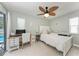 Serene bedroom with workspace, neutral tones, and sliding door to the outdoors at 4415 Sylvania Ave, North Port, FL 34286