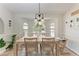 Charming dining room with a wood table, decorative chandelier, and natural light at 4415 Sylvania Ave, North Port, FL 34286