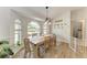 Bright dining room features wood floors, a large window, and a modern light fixture at 4415 Sylvania Ave, North Port, FL 34286
