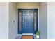 The front door is a beautiful blue, with decorative windows on either side, and an electronic lock at 4415 Sylvania Ave, North Port, FL 34286