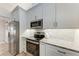 Bright kitchen features stainless steel appliances, granite countertops and modern white cabinets at 4415 Sylvania Ave, North Port, FL 34286
