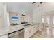 Granite countertop bar overlooking living room with stainless steel dishwasher at 4415 Sylvania Ave, North Port, FL 34286