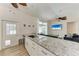 Kitchen island with granite countertops and a view of the living room and sliding glass door to the pool at 4415 Sylvania Ave, North Port, FL 34286