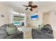 Comfortable living room with hardwood floors, neutral walls, and a sliding glass door to the pool at 4415 Sylvania Ave, North Port, FL 34286