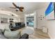Open concept living room with a view of the kitchen and sliding glass door to the pool at 4415 Sylvania Ave, North Port, FL 34286