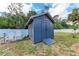 Backyard shed with a ramp entrance and adjacent seating, offering practical storage space at 4415 Sylvania Ave, North Port, FL 34286