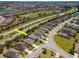 Aerial view of a beautiful neighborhood with a golf course, ponds, and well-maintained landscaping at 4529 Golden Gate Cv, Bradenton, FL 34211