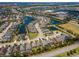 Aerial view of a stunning lakeside neighborhood, showcasing pristine landscaping and charming single-Gathering houses at 4529 Golden Gate Cv, Bradenton, FL 34211