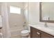 Bathroom with a combined shower and tub, traditional vanity and decorative mirror at 4529 Golden Gate Cv, Bradenton, FL 34211
