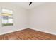 Cozy bedroom with wood floors, a ceiling fan and a large window at 4529 Golden Gate Cv, Bradenton, FL 34211