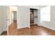 Bright bedroom featuring wood floors, closet with built-ins, and large window for ample natural light at 4529 Golden Gate Cv, Bradenton, FL 34211