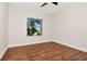 Empty bedroom featuring beautiful wood-look floors and a large window for ample light at 4529 Golden Gate Cv, Bradenton, FL 34211