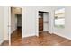 Bright bedroom featuring wood floors, closet with built-ins, and large window for ample natural light at 4529 Golden Gate Cv, Bradenton, FL 34211
