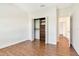 Bright bedroom featuring wood floors, closet with built-ins, and an open doorway at 4529 Golden Gate Cv, Bradenton, FL 34211