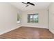 This bedroom features a ceiling fan, wood-look floors and has a window and door at 4529 Golden Gate Cv, Bradenton, FL 34211