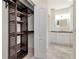 A custom closet leads to the ensuite bath, featuring shelving and storage at 4529 Golden Gate Cv, Bradenton, FL 34211
