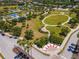 An aerial view showcasing the community park including tennis courts, playground, water park, and grassy field at 4529 Golden Gate Cv, Bradenton, FL 34211