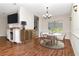 Well-lit dining area featuring elegant chandelier, modern decor, and adjacent kitchen at 4529 Golden Gate Cv, Bradenton, FL 34211