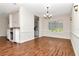Bright dining room with wood floors, modern lighting fixture, and a large window at 4529 Golden Gate Cv, Bradenton, FL 34211