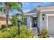 Inviting front entrance with decorative lamp, lush greenery, and a cozy, welcoming atmosphere at 4529 Golden Gate Cv, Bradenton, FL 34211