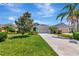 Charming single-story home with a well-manicured lawn, a lush magnolia tree, and a paved driveway at 4529 Golden Gate Cv, Bradenton, FL 34211