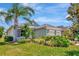 Charming single-story home featuring lush landscaping, a well-manicured lawn, and a cozy front porch at 4529 Golden Gate Cv, Bradenton, FL 34211
