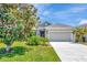 Charming single-story home featuring lush landscaping, a well-manicured lawn, and a welcoming porch at 4529 Golden Gate Cv, Bradenton, FL 34211
