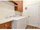 A well-lit laundry room features a washer and dryer, storage cabinets, and counter space at 4529 Golden Gate Cv, Bradenton, FL 34211
