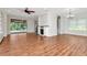 Spacious living room with beautiful hardwood floors, fireplace, and access to the pool at 4529 Golden Gate Cv, Bradenton, FL 34211