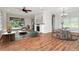 Open-concept living space with seamless flow to outdoor pool area, modern furnishings, and fireplace at 4529 Golden Gate Cv, Bradenton, FL 34211