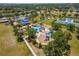 Aerial view of a neighborhood park with tennis courts, picnic pavilions, playground, and water splash park at 4529 Golden Gate Cv, Bradenton, FL 34211
