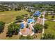 Aerial view showcasing a vibrant community playground with splash pad, play structures, and covered seating area at 4529 Golden Gate Cv, Bradenton, FL 34211