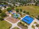 Overhead view of a vibrant playground with slides, swings, a splash pad, and a covered picnic area at 4529 Golden Gate Cv, Bradenton, FL 34211