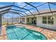 Outdoor screened-in pool area with swimming pool, hot tub, and patio area at 4529 Golden Gate Cv, Bradenton, FL 34211