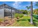 The pool and spa area is surrounded by lush landscaping and a white fence at 4529 Golden Gate Cv, Bradenton, FL 34211