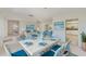 Bright dining room with blue and white decor, white table, and open layout to kitchen and living areas at 4908 Commonwealth Rd, Palmetto, FL 34221