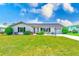 Charming single-story home with well-manicured lawn, lush landscaping, and a clean, inviting exterior at 4908 Commonwealth Rd, Palmetto, FL 34221