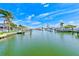 Scenic waterfront view with lush greenery, boats docked, and a clear blue sky at 4908 Commonwealth Rd, Palmetto, FL 34221